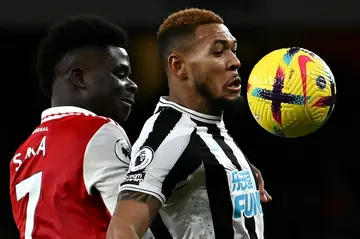 Arsenal's Bukayo Saka (left) battles with Newcastle midfielder Joelinton