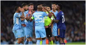 Man City players interact with referee Istvan Kovacs after awarding Real Madrid a penalty during the UEFA Champions League Semi-Final clash. Photo by Marc Atkins.