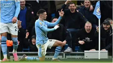 Phil Foden celebrates after scoring during the Premier League match between Manchester City and Manchester United at the Etihad Stadium. Photo by Paul Ellis.