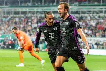 Harry Kane and teammates celebrate his first goal for new club, Bayern Munich, in their Bundeliga victory over Werder Bremen.