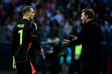 Germany coach Julian Nagelsmann talks to goalkeeper Manuel Neuer during the draw with Ukraine