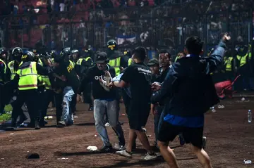 Tragedy: A fan is carried off the pitch