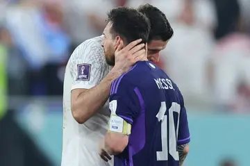 Poland forward Robert Lewandowski and Argentina's Lionel Messi embrace after their World Cup clash