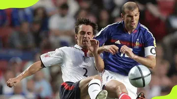 Garry Neville fights for the ball against Zinedine Zidane