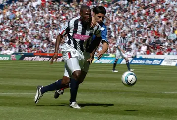 Kevin Campbell (L), playing for West Brom,  attempts to get past Portsmouth defender Dejan Stefanovic