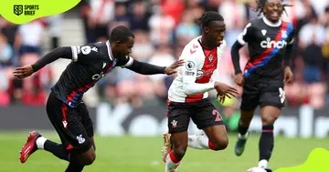 Southampton's FC Kamaldeen Sulemana (in white) and Crystal Palace's (in black) Tyrick Mitchell battle for the ball on April 15, 2023, in Southampton, England