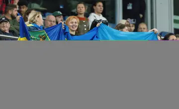 Supporters of Shakhtar Donetsk wave flags during their side's clash with Porto in Hamburg