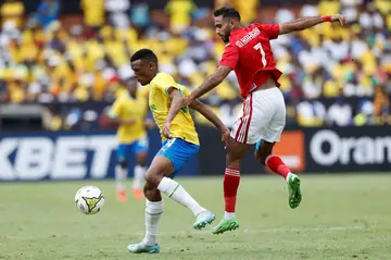 Al Ahly star Mahmoud Kahraba (R) fights for the ball during a 2023 CAF Champions League group match against  Mamelodi Sundowns of South Africa in Pretoria.