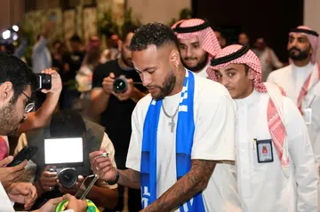 Neymar signs autographs as he arrives in Riyadh