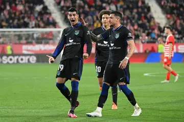 Atletico Madrid forward Alvaro Morata (L) celebrates scoring his team's goal against Girona at Montilivi on Monday