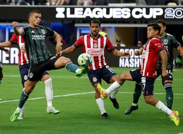 Los Angeles Galaxy's Dejan Joveljic scores in front of Jesus Sanchez in a 2-0 friendly win over Chivas Guadalajara at Sofi Stadium in Los Angeles