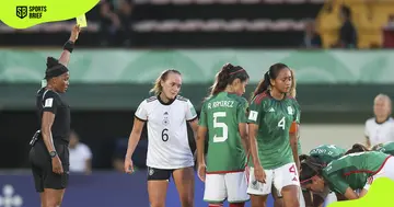 Akhona Makalima issues a yellow card to one of Germany's players during a World Cup match against Mexico.