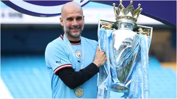 Pep Guardiola poses for a photograph with the Premier League Trophy following the Premier League match between Manchester City and Chelsea FC at Etihad Stadium. Photo by Catherine Ivill.