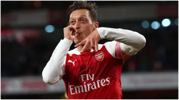 Mesut Ozil celebrates after scoring during the Premier League match between Arsenal FC and Leicester City at Emirates Stadium. Photo by Clive Rose.