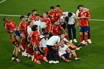 Spain's players celebrate after winning their Euro 2024 semi-final against France in Munich