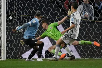 Luciano Rodriguez (L) heads the winner as Uruguay take the Under-20 World cup