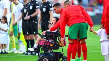 Cristiano Ronaldo, escort, Portugal, friendly, Euro 2024, wheelchair, cerebral palsy, heartwarming gesture.