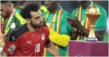 Egyp's Mohamed Salah walks to the podium for his silver medal at AFCON 2021.