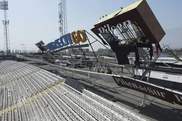 The buckled advertising structure that collapsed under the weight of supporters that had climbed on top