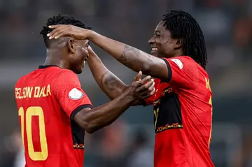 Angola scorers Gelson Dala (L) and Mabululu celebrate in Bouake