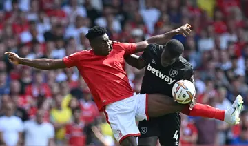 New Nottingham Forest signing Taiwo Awoniyi (L) clashes with West Ham defender Kurt Zouma