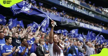 Chelsea supporters wave flags after a match.