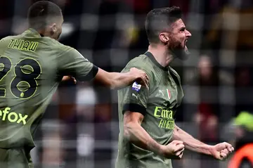 Olivier Giroud (R) celebrates after scoring his seventh Serie A goal of the season