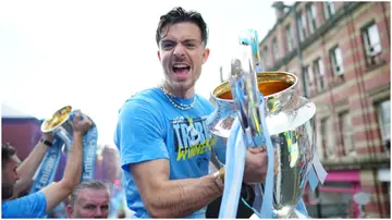 Jack Grealish celebrates with the UEFA Champions League trophy during the Manchester City trophy parade. Photo by Tom Flathers.