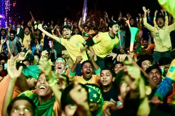 Football fans celebrate as Brazil scores against South Korea while watching their World Cup match on December 6