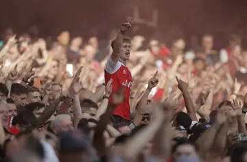 Celebrating Arsenal fans during the Premier League match against Tottenham Hotspur at the Emirates Stadium on September 26th 2021, in London