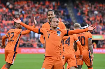 Xavi Simons celebrates his first international goal as Virgil van Dijk offers congratulations