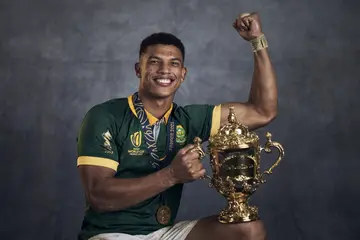 Kurt Lee Arendse poses with the Webb Ellis Cup during the South Africa Winners Portrait shoot 