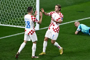 Croatia midfielder Lovro Majer (right) celebrates scoring his team's fourth goal against Canada