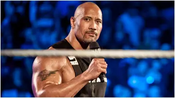 Dwayne Johnson, aka The Rock, enters the ring to talk smack during the WWE Raw event at Rose Garden arena in Portland. Photo by Chris Ryan.