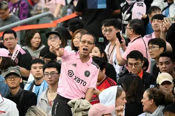 Angry fans in Hong Kong boo and give thumbs-down gestures after Lionel Messi failed to take the field in a sold-out and much-hyped friendly
