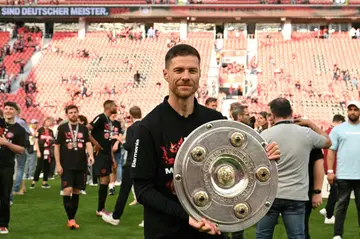 'Outstanding': Bayer Leverkusen coach Xabi Alonso poses with the Bundesliga trophy