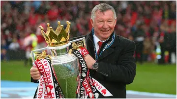 Sir Alex Ferguson celebrates with the Premier League trophy at Old Trafford. Photo by Alex Livesey.