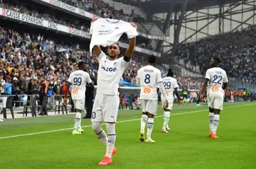 Dimitri Payet holds up a short to thank Marseille fans after scoring