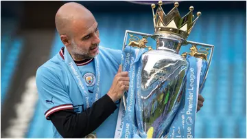 Pep Guardiola poses with the Premier League trophy after the Premier League match between Manchester City and Chelsea at the Etihad Stadium. Photo by Visionhaus.