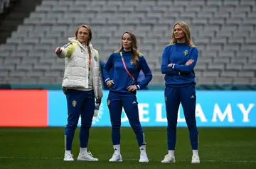 Kosovare Asllani (C) inspects the pitch at a rainy Eden Park along with her teammates Magdalena Eriksson and Fridolina Rolfo