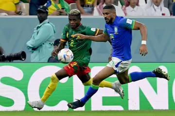 Cameroon African Nations Championship match-winner Jerome Mbekeli (L) playing against Brazil during the 2022 World Cup in Qatar.