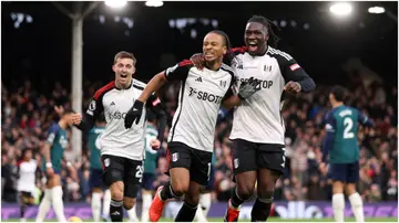 Bobby Reid celebrates with Calvin Bassey after scoring during the Premier League match between Fulham FC and Arsenal FC at Craven Cottage. Photo by Alex Pantling.