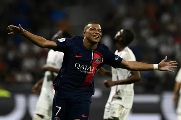Kylian Mbappe celebrates after scoring in PSG's 4-1 win at Lyon on Sunday