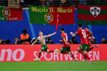 Francisco Conceicao (L) wheels away after scoring his country's winner in their opening Euro 2024 match