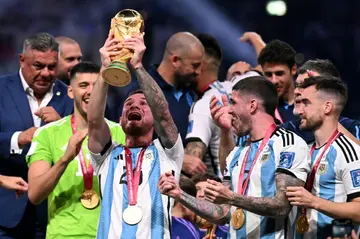 Alexis Mac Allister lifts the World Cup after Argentina's penalty shootout win over France in the final
