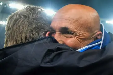Luciano Spalletti (R) embraces a fellow staff member after winning his first Serie A title