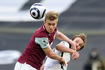 Former Burnley player Ben Mee (left) has signed a contract with Brentford