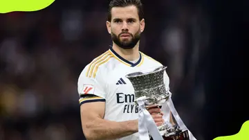 Real Madrid's Nacho holds the Super Cup trophy after winning in 2024 