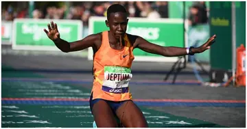 Kenya's Judith Jeptum reacts after crossing the finish line to win the 46th edition of the Paris Marathon. Photo by FRANCK FIFE.