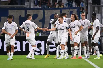 Marseille's players celebrate after scoring a goal during the French L1 football match between Olympique Marseille (OM) and Stade de Reims at Stade Velodrome in Marseille, southern France on August 7, 2022.